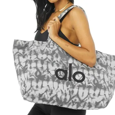 Printed canvas tote carried over a shoulder