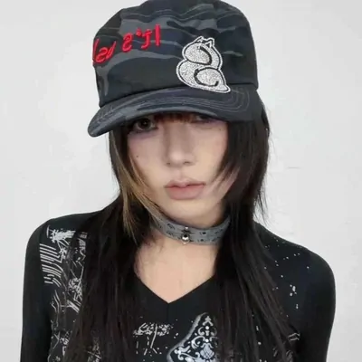 Person wearing a black embroidered cap