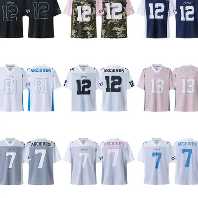 Numbered football shirts in white and grey laid in rows