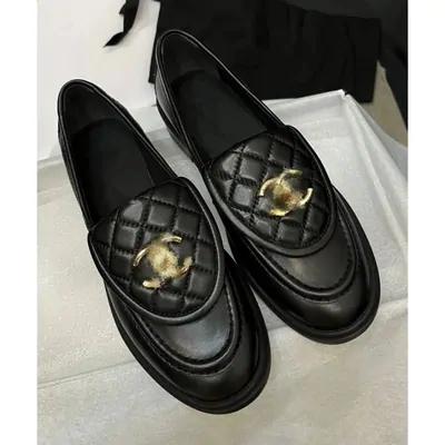 Black quilted loafers photographed from above